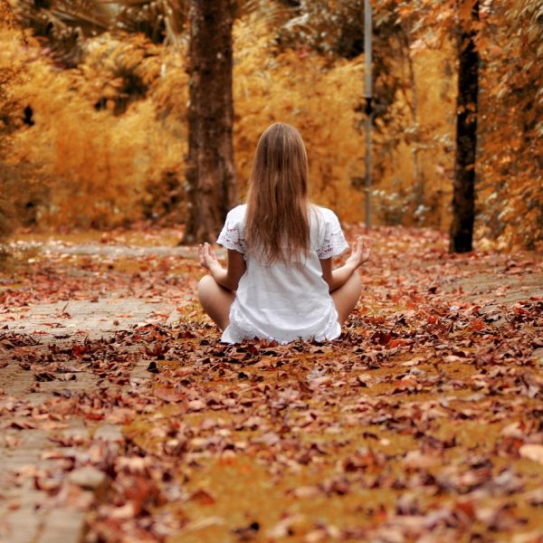 femme qui médite dans un chemin en automne